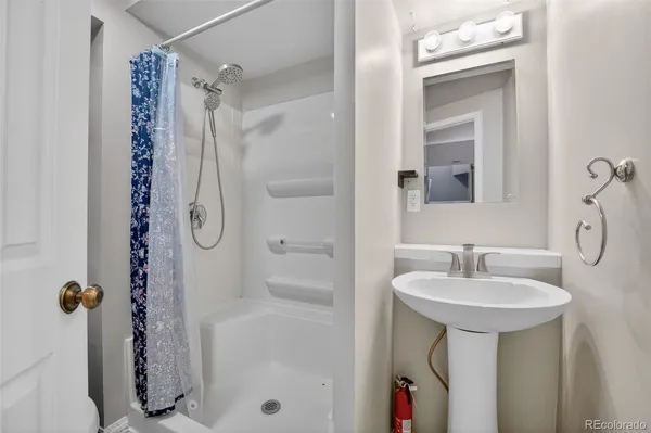 a bathroom with a tub sink and mirror