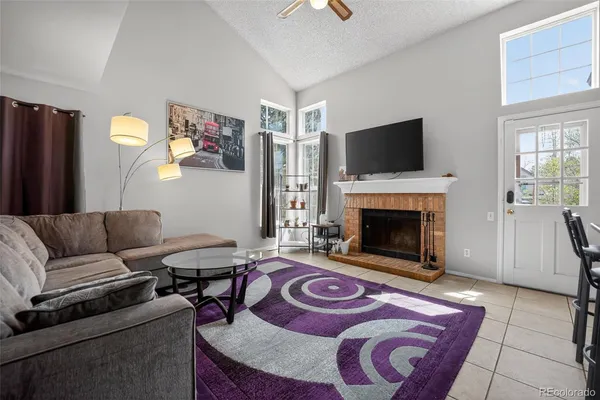 a living room with furniture and a fireplace