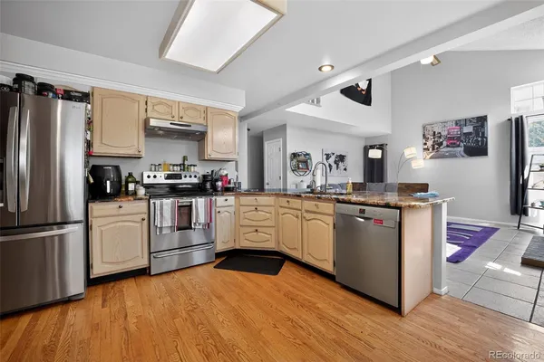 a kitchen with stainless steel appliances and white cabinets