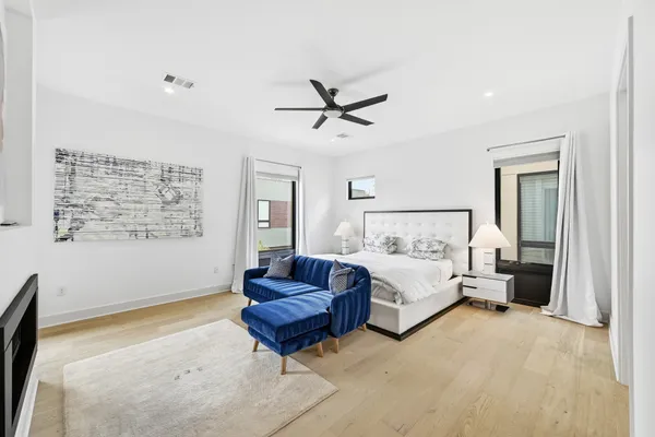 a spacious bedroom with a bed and ceiling fan