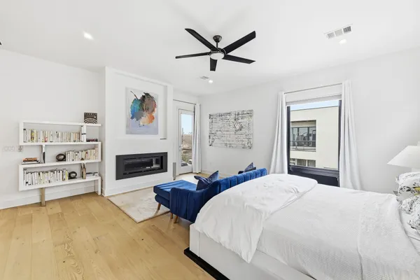 a spacious bedroom with a bed and a fireplace