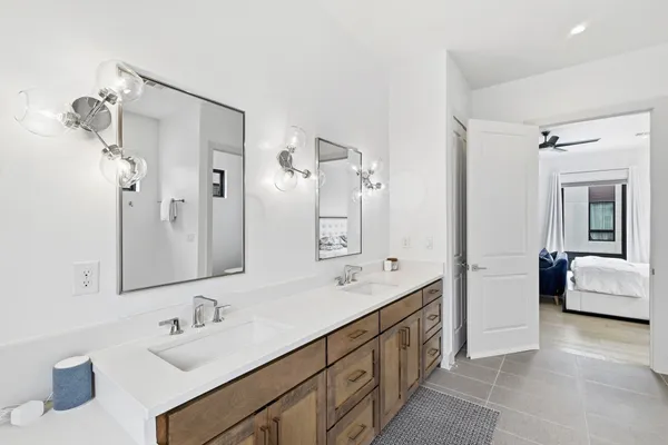 a spacious bathroom with a double vanity sink mirror double and bathtub