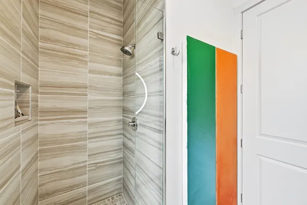 a bathroom with a shower and a glass door