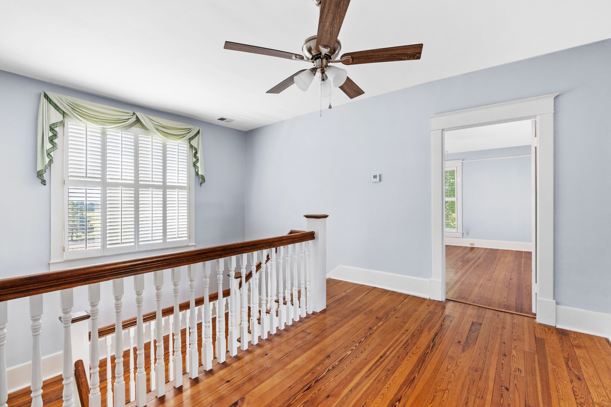 10587 Fulton Road Ripley, TN 38063 - Photo 18 of 29 a view of an empty room with wooden floor and a window