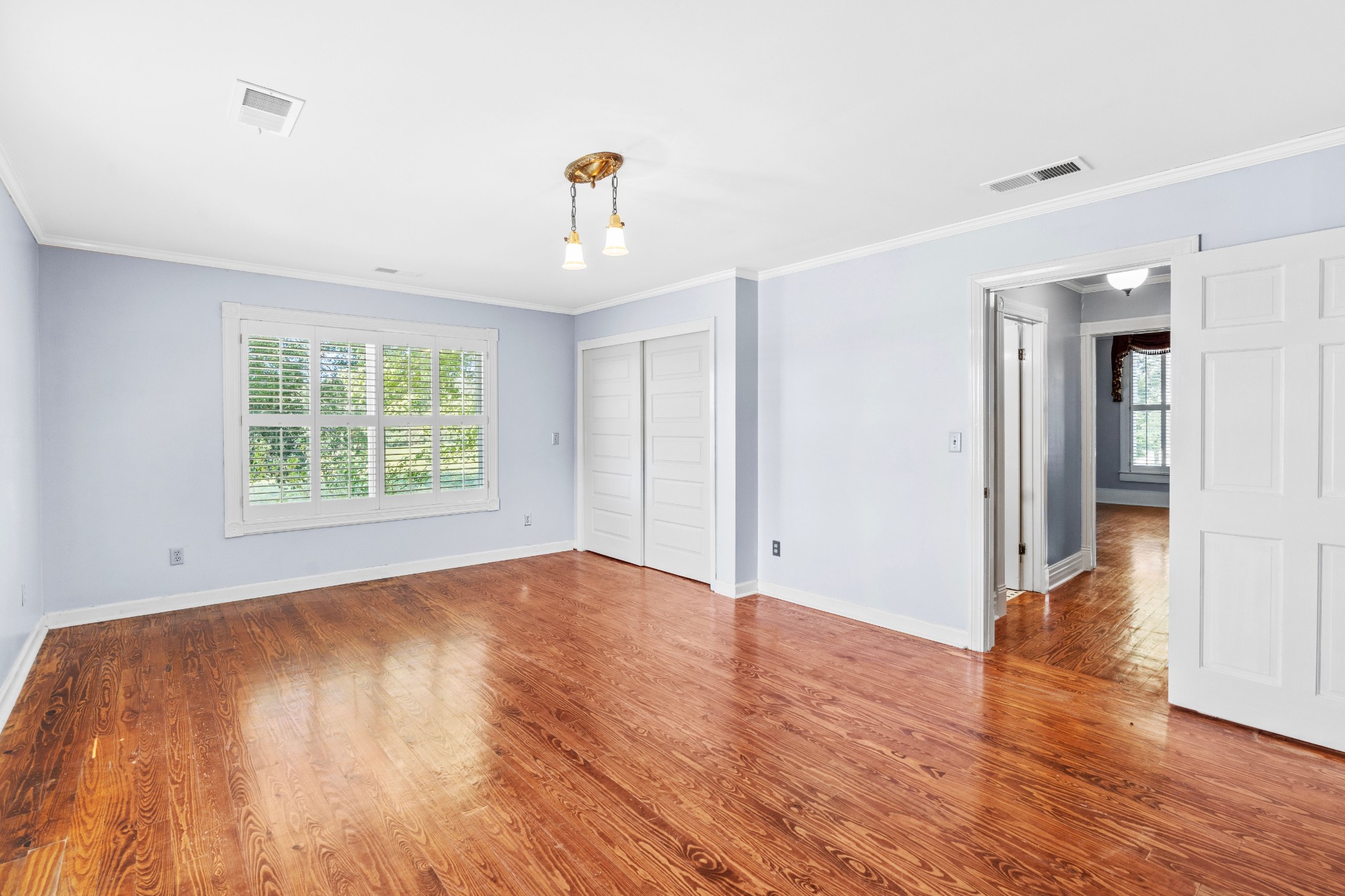 10587 Fulton Road Ripley, TN 38063 - Photo 10 of 29 an empty room with wooden floor and windows