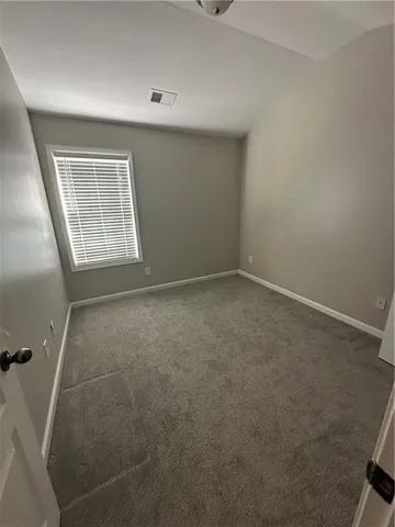 an empty room with a empty space and windows