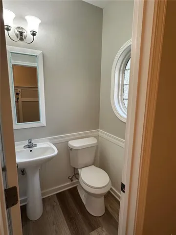 a white toilet sitting next to a bathroom sink