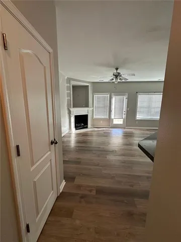 a view of entryway and hall with wooden floor