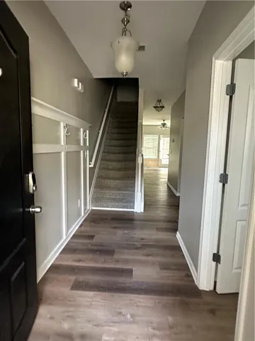 a view of entryway and hall with wooden floor
