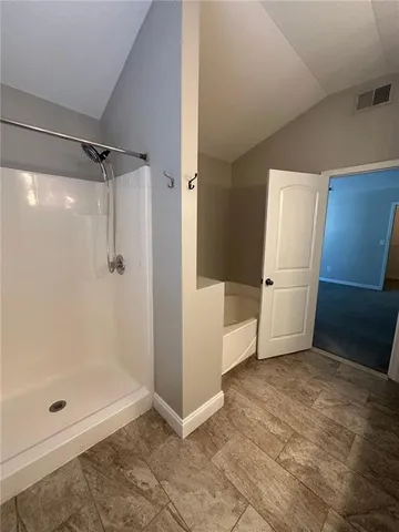 a view of a bathroom with a glass door shower