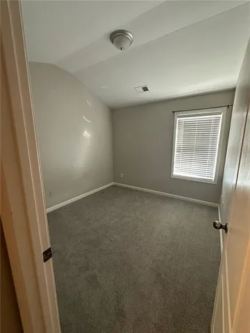 an empty room with a empty space and windows