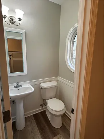 a white toilet sitting next to a bathroom sink