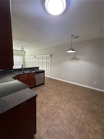 a kitchen with stainless steel appliances granite countertop a sink and a stove