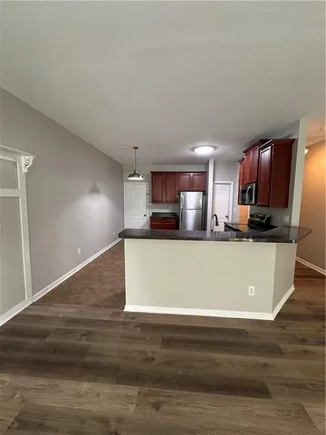 a view of kitchen with stainless steel appliances kitchen island sink and cabinets