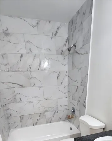a bathroom with a white sink and a toilet