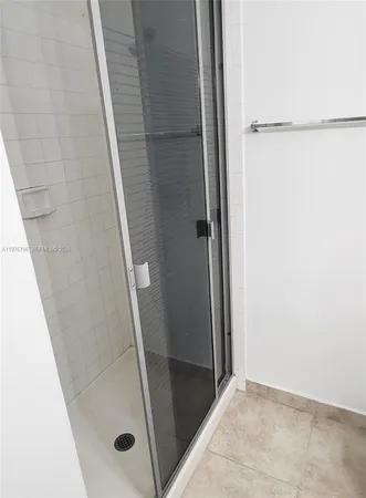 a bathroom with a glass door shower