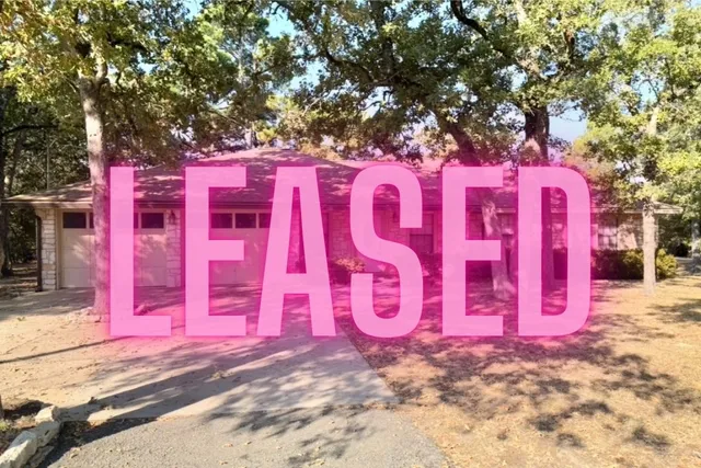 a street sign on a wall next to a road