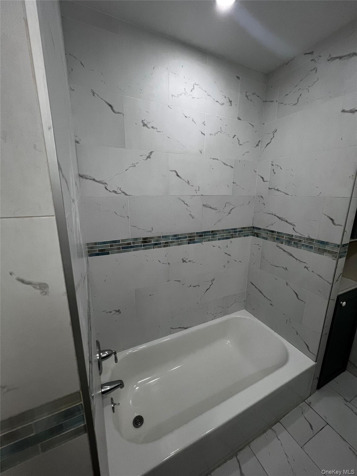 349 Warwick Avenue Mount Vernon, NY 10553 - Photo 3 of 15 Full bath featuring marble finish floors and washtub / shower combination