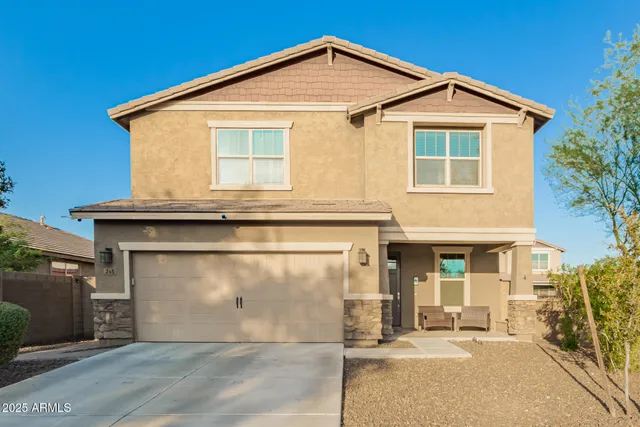 a view of a house with a yard and garage