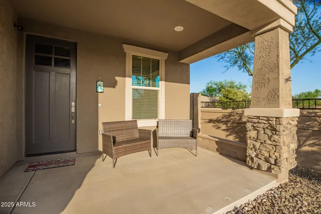 a balcony with furniture and a potted plant