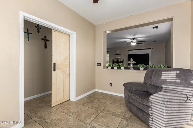 a living room with furniture and a large mirror
