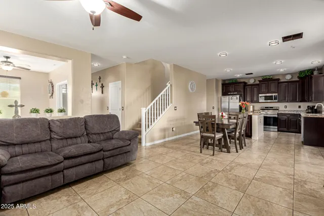 a living room with furniture and kitchen view
