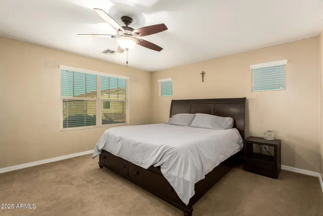 a bedroom with a large bed and a window