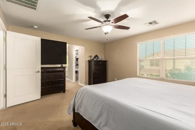 a bed room with a bed and a television