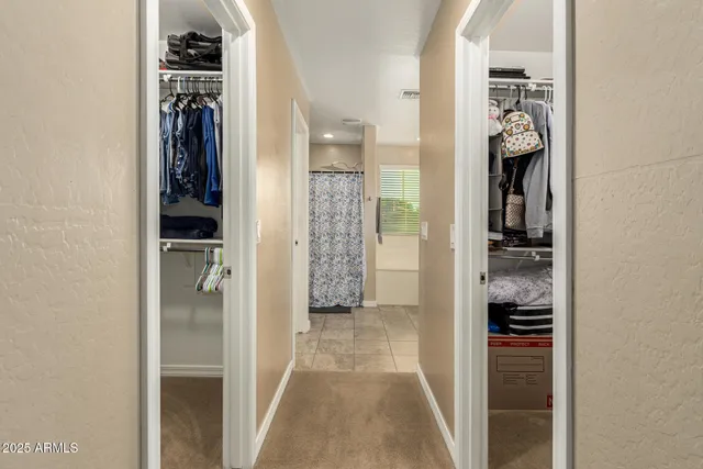 a view of a walk in closet and bathroom