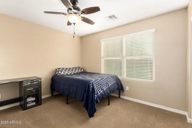a bedroom with a bed dresser and a window