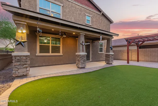 a view of a porch with a table and chairs