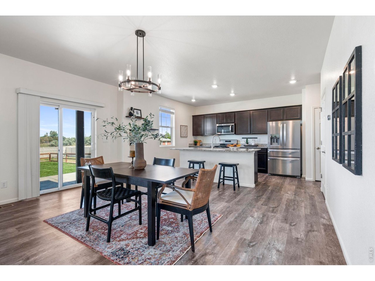 10080 Cedar Street Firestone, CO 80504 - Photo 12 of 38 Dining and kitchen blend to create entertaining space with sliding glass door for backyard entry