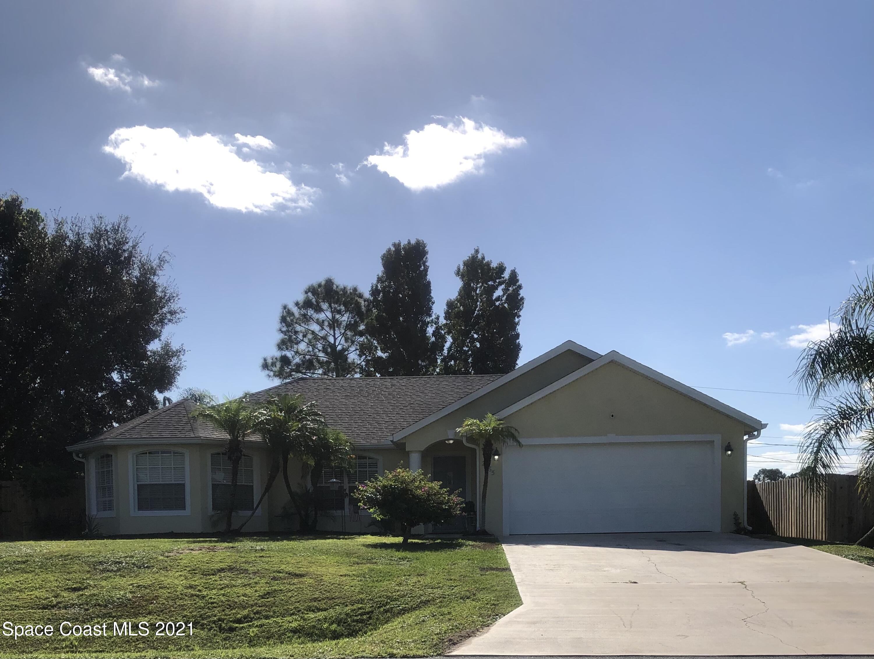 2865 Digby Road Southeast Palm Bay, FL 32909 - Photo 1 of 42 a front view of a house with a garden and yard