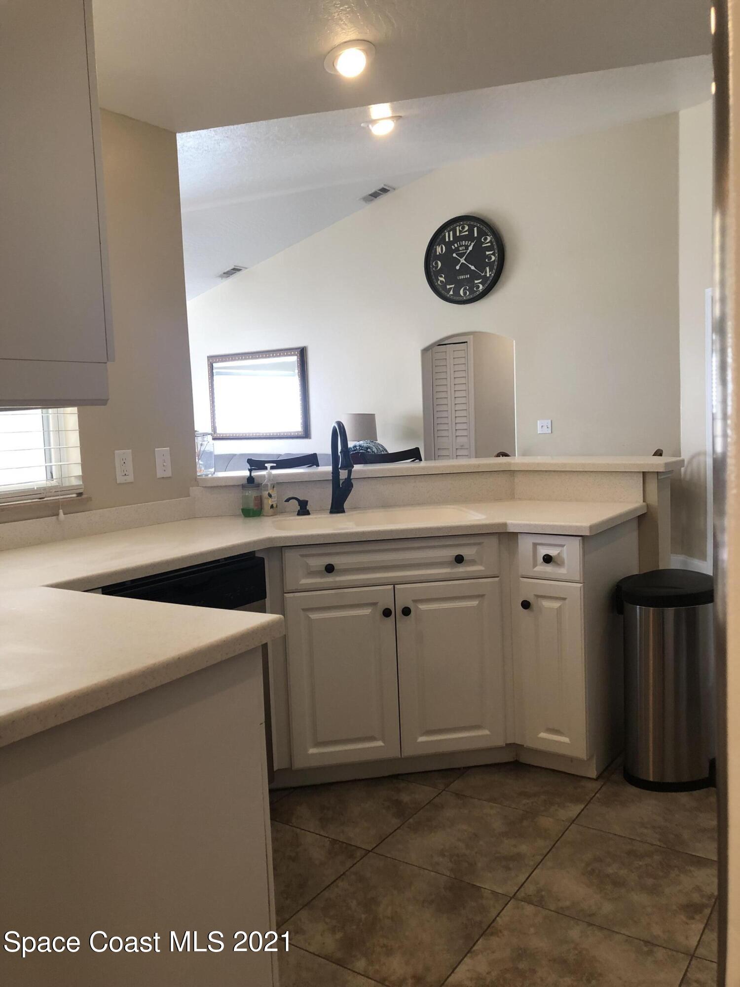 2865 Digby Road Southeast Palm Bay, FL 32909 - Photo 11 of 42 a kitchen with a sink a stove and cabinets