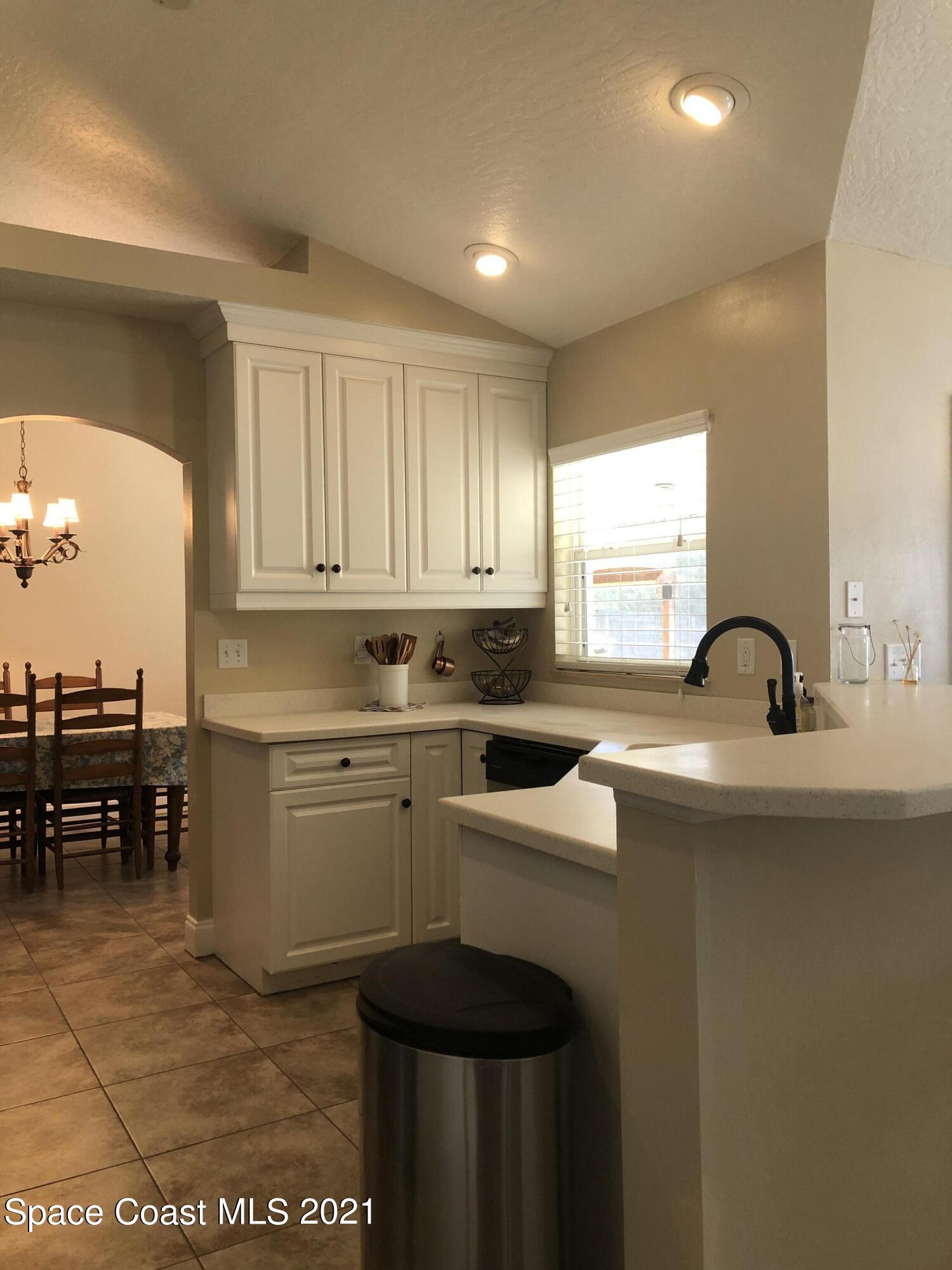 2865 Digby Road Southeast Palm Bay, FL 32909 - Photo 14 of 42 a kitchen with a sink cabinets and appliances