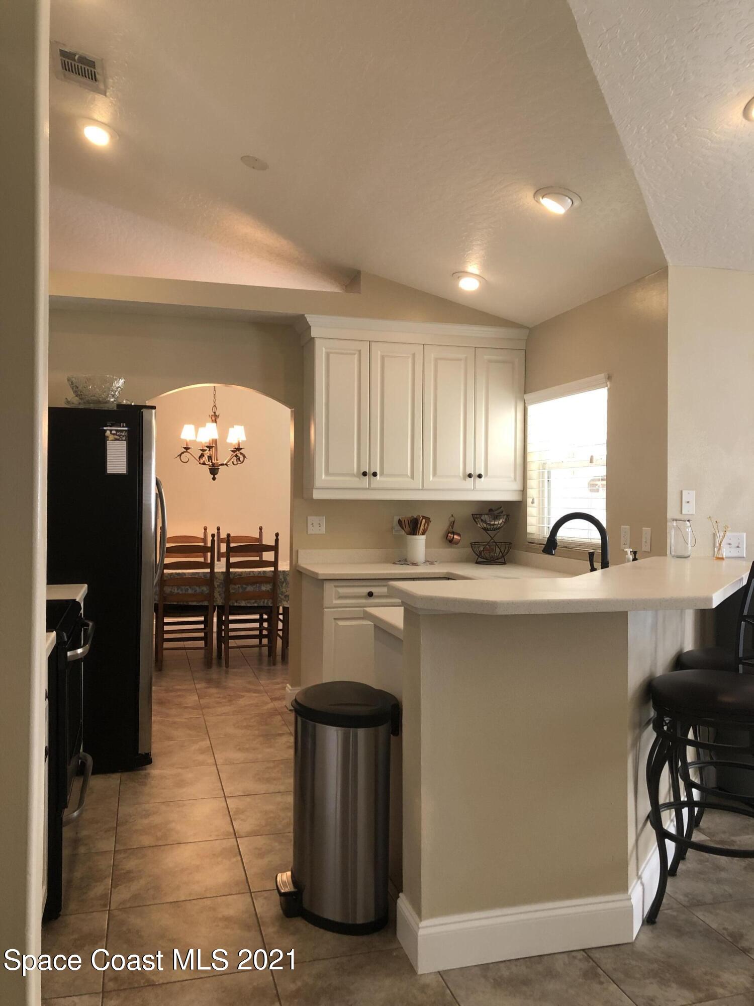 2865 Digby Road Southeast Palm Bay, FL 32909 - Photo 15 of 42 a open kitchen with stainless steel appliances granite countertop a stove and a sink