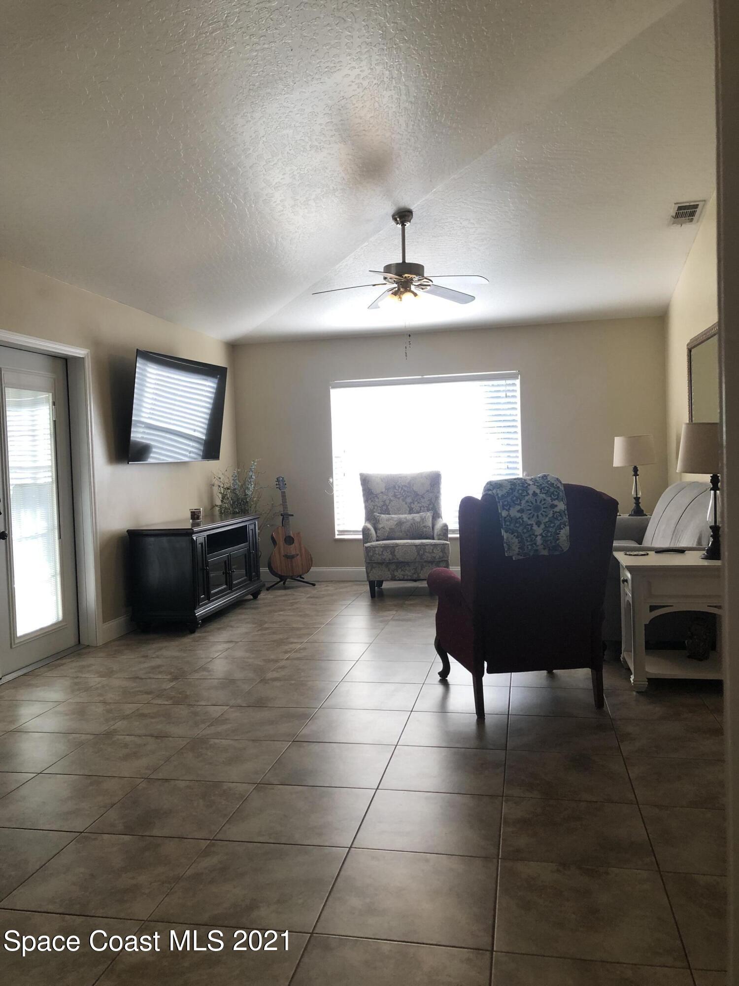2865 Digby Road Southeast Palm Bay, FL 32909 - Photo 16 of 42 a living room with furniture and a flat screen tv
