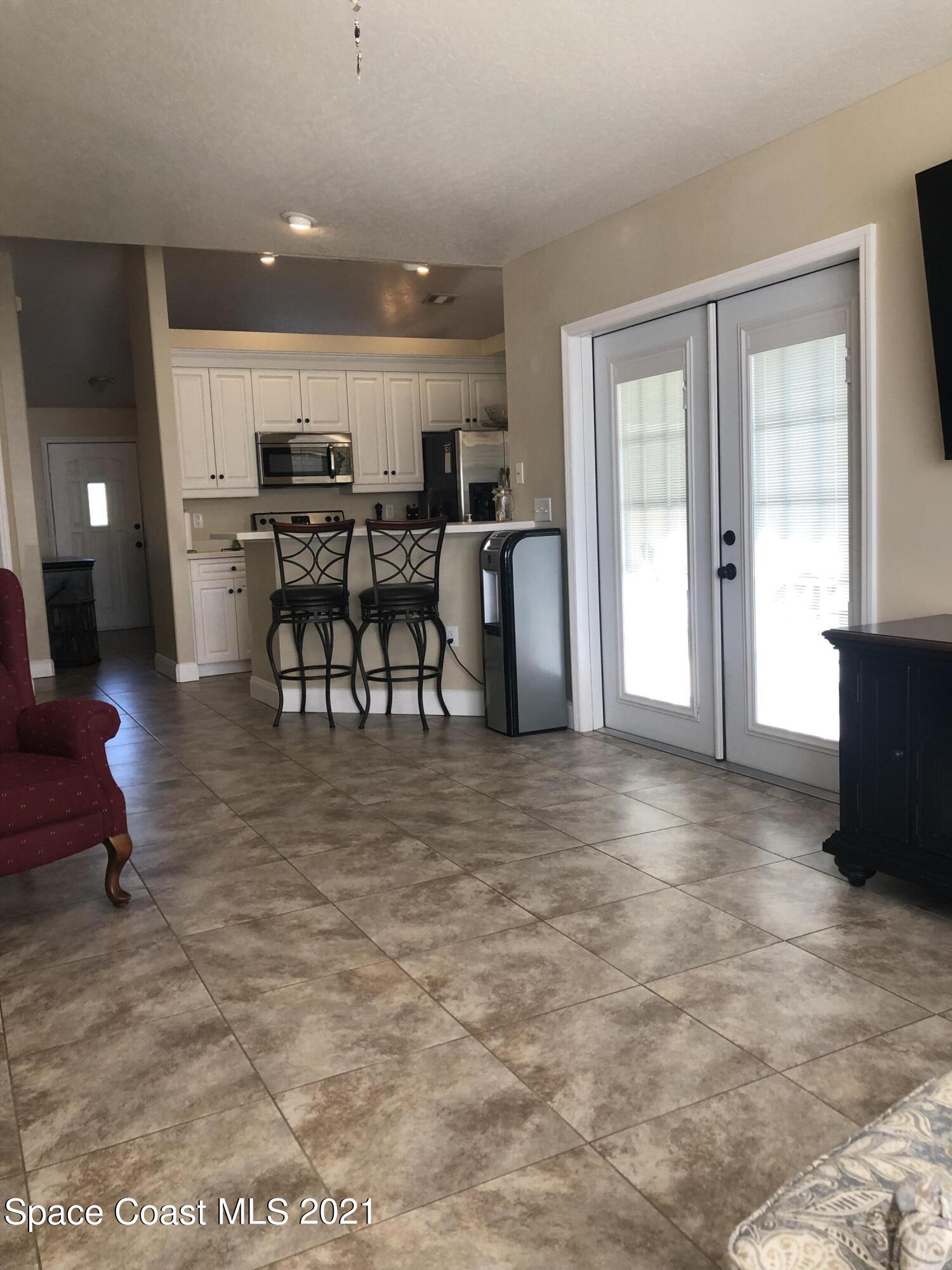 2865 Digby Road Southeast Palm Bay, FL 32909 - Photo 17 of 42 a view of a living room and kitchen