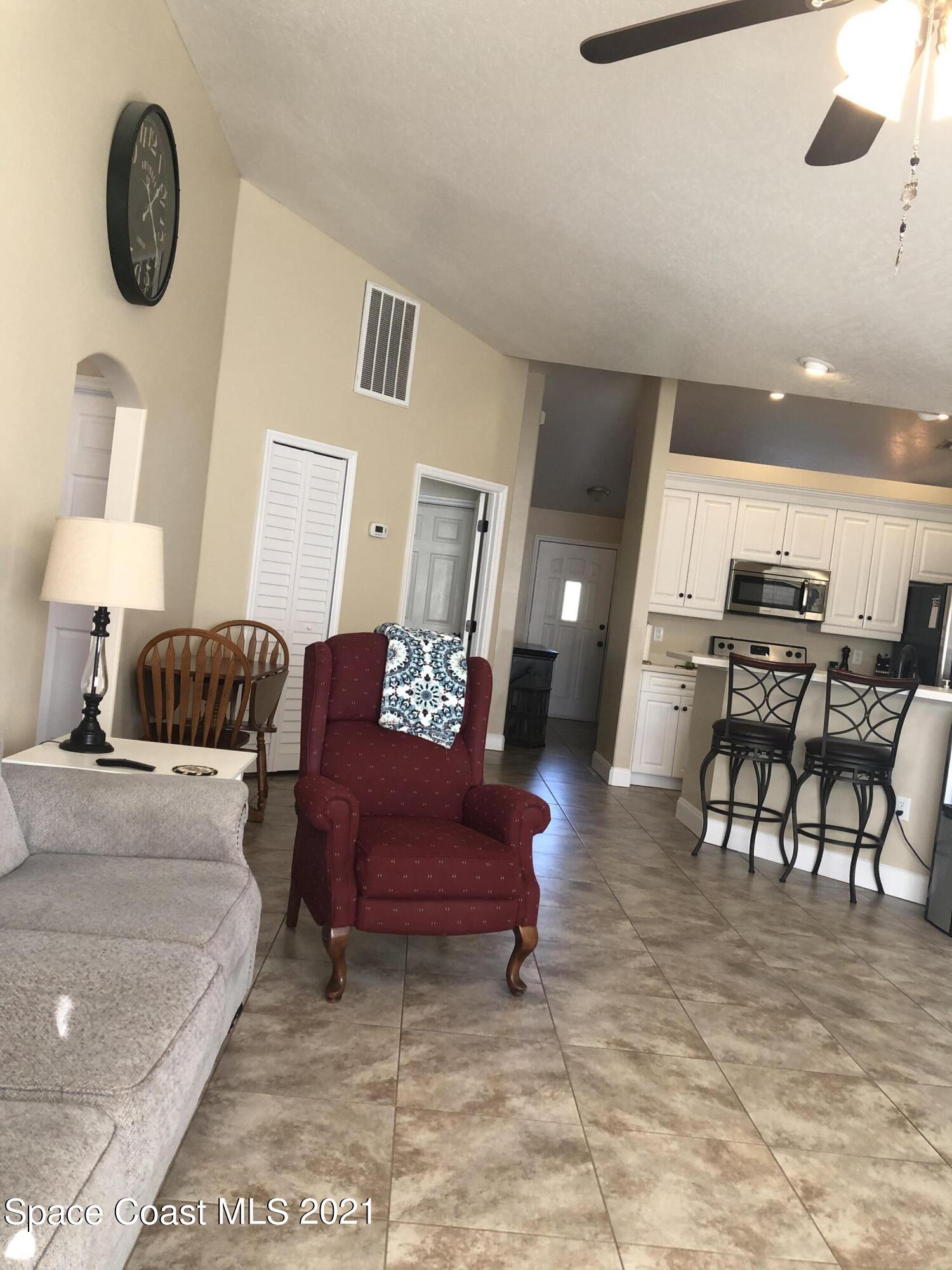2865 Digby Road Southeast Palm Bay, FL 32909 - Photo 18 of 42 a living room with furniture and a chair