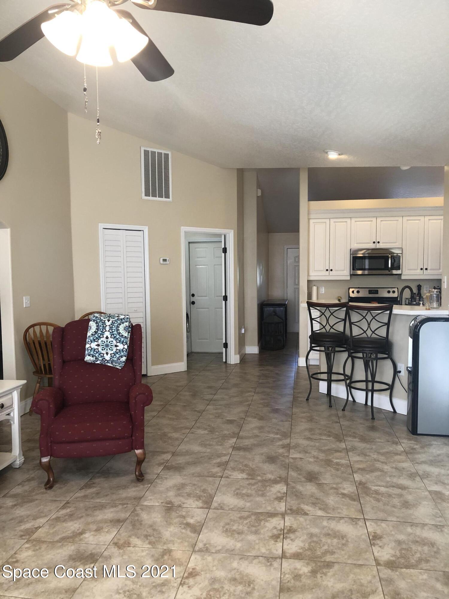 2865 Digby Road Southeast Palm Bay, FL 32909 - Photo 19 of 42 a living room with furniture and kitchen view