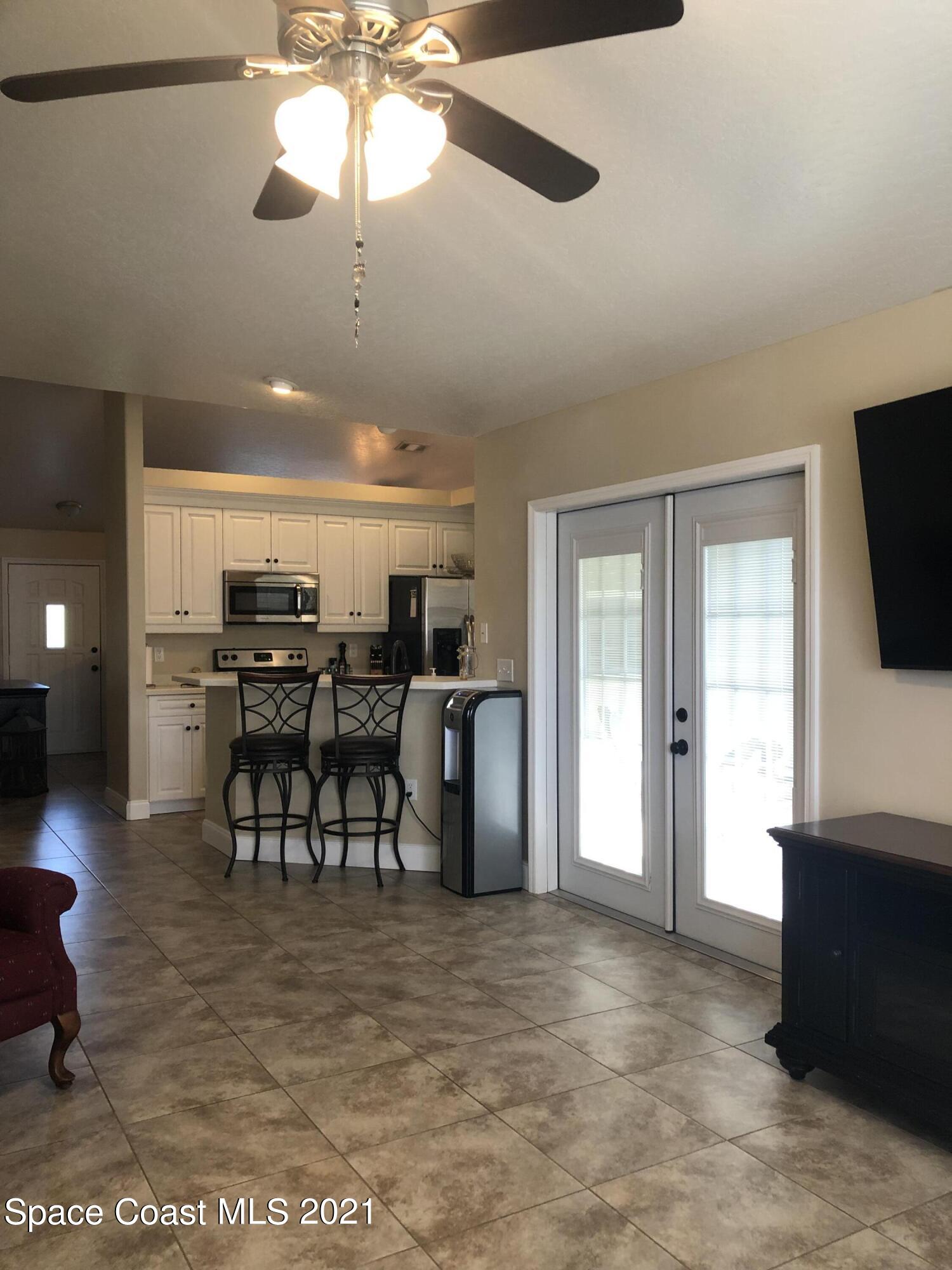 2865 Digby Road Southeast Palm Bay, FL 32909 - Photo 20 of 42 a view of a livingroom with furniture and a flat screen tv