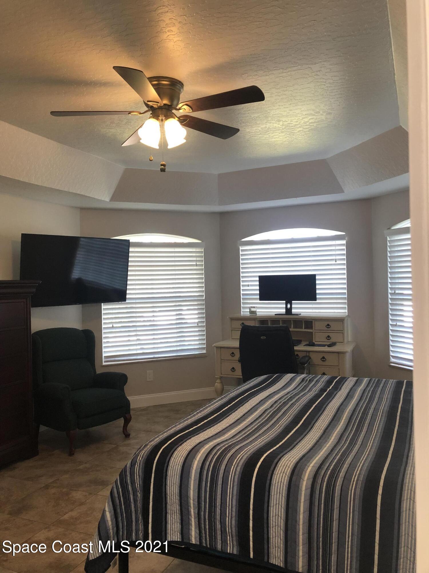 2865 Digby Road Southeast Palm Bay, FL 32909 - Photo 24 of 42 a bedroom with a bed and a flat screen tv