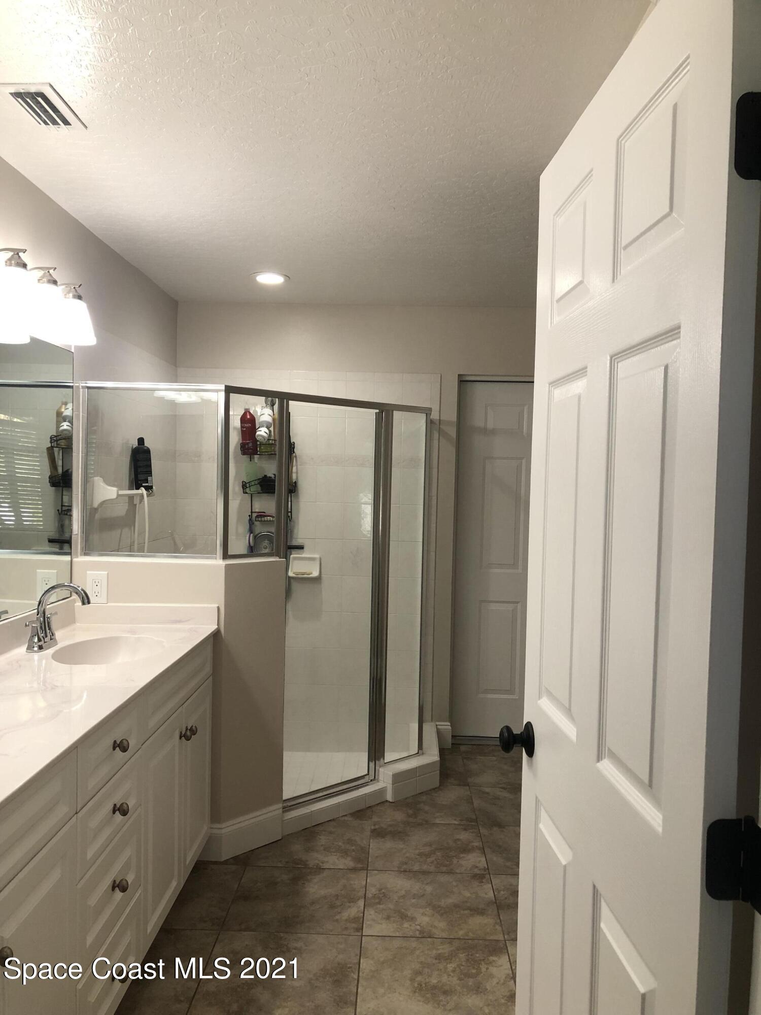 2865 Digby Road Southeast Palm Bay, FL 32909 - Photo 25 of 42 a bathroom with a double vanity sink and mirror