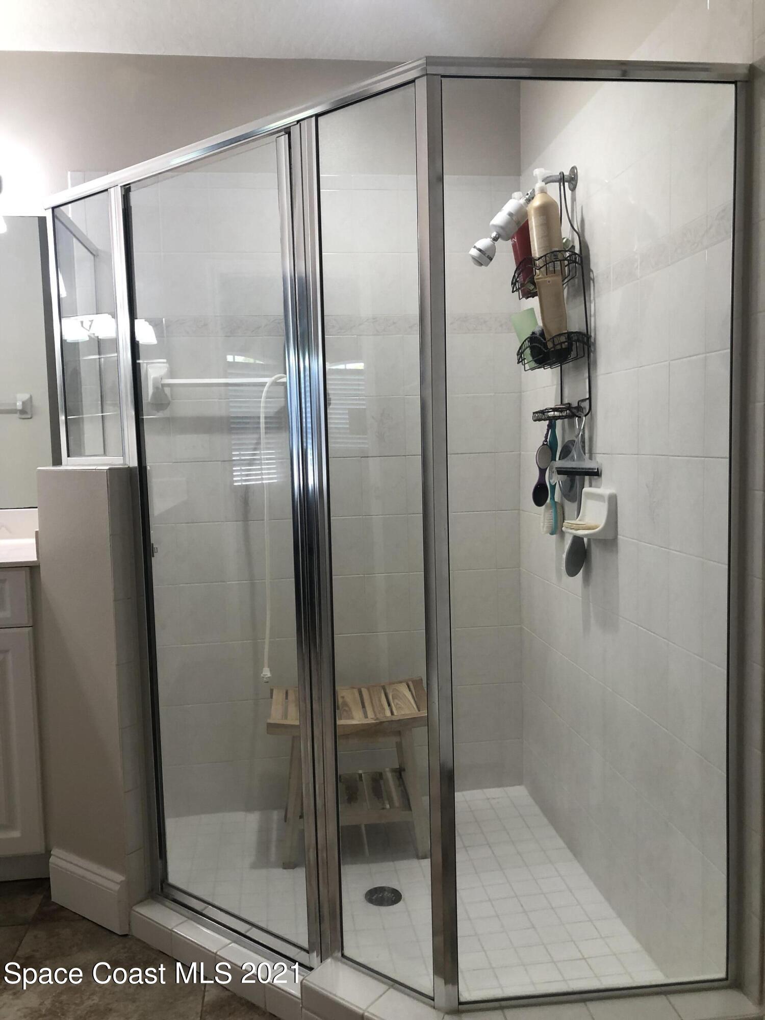 2865 Digby Road Southeast Palm Bay, FL 32909 - Photo 29 of 42 a bathroom with a glass shower door