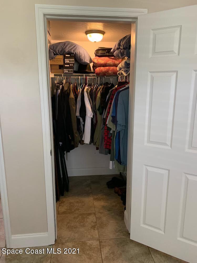 2865 Digby Road Southeast Palm Bay, FL 32909 - Photo 30 of 42 a view of walk in closet with clothes and shoes