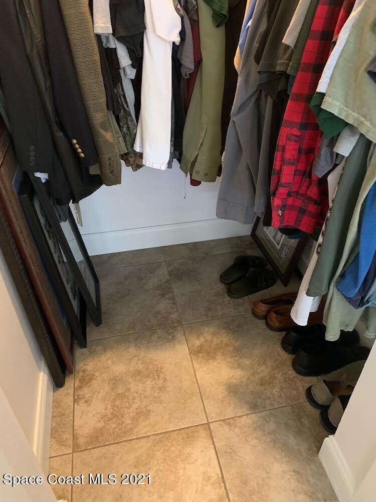 2865 Digby Road Southeast Palm Bay, FL 32909 - Photo 31 of 42 a view of walk in closet with clothes and shoes