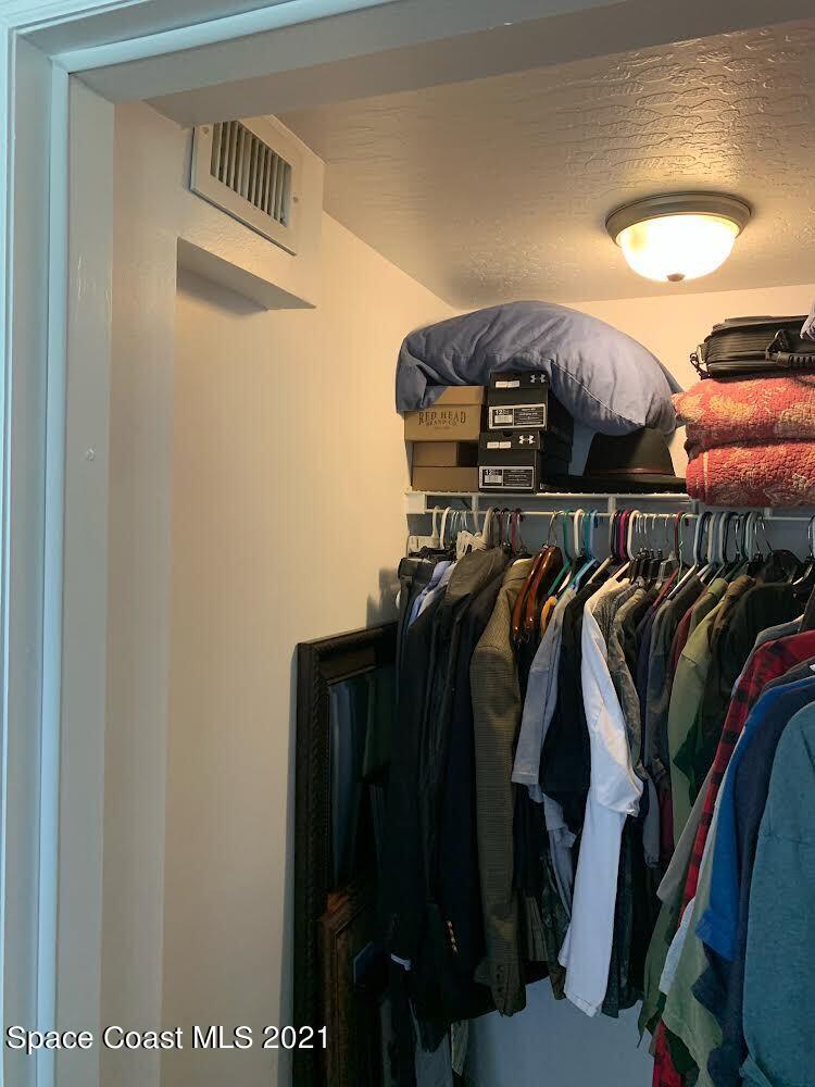 2865 Digby Road Southeast Palm Bay, FL 32909 - Photo 32 of 42 a view of walk in closet with clothes and shoes