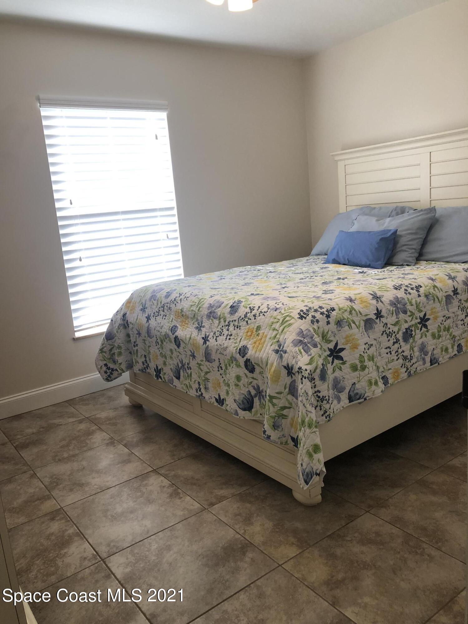 2865 Digby Road Southeast Palm Bay, FL 32909 - Photo 33 of 42 a bed sitting in a bedroom next to a window
