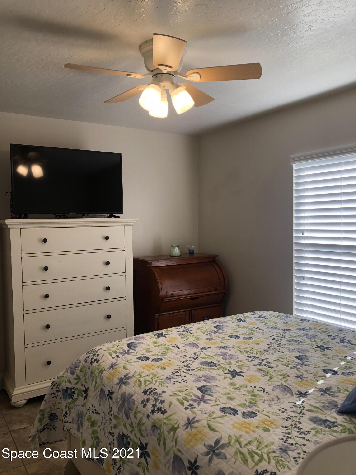 2865 Digby Road Southeast Palm Bay, FL 32909 - Photo 34 of 42 a bedroom with a bed and a flat screen tv