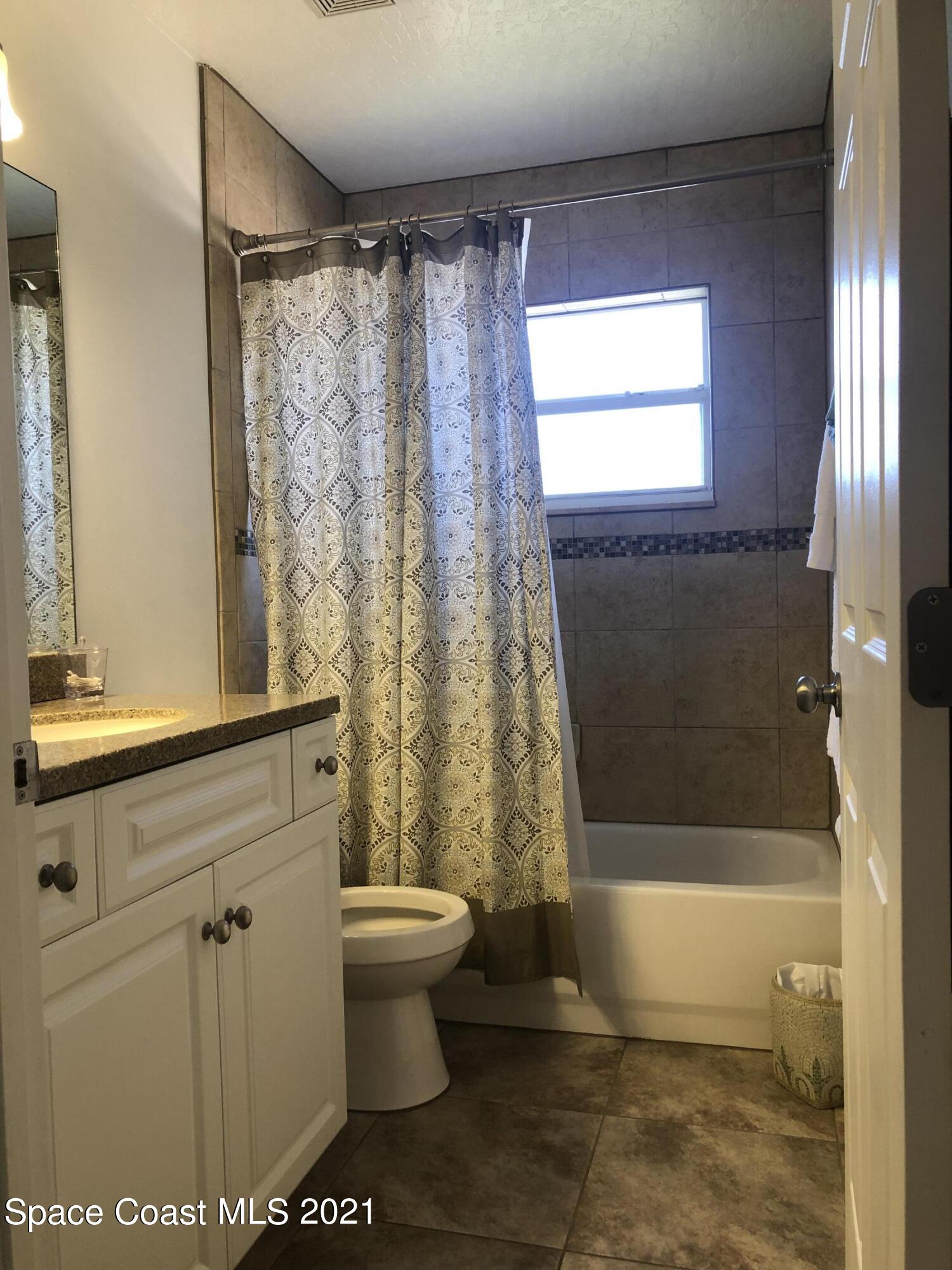 2865 Digby Road Southeast Palm Bay, FL 32909 - Photo 35 of 42 a bathroom with a toilet a sink and a bathtub